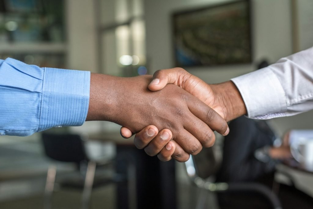 Business partners shaking hands after signing an agreement